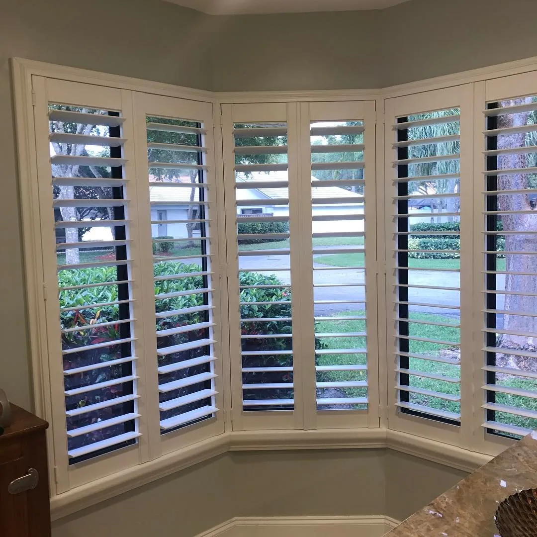 A kitchen with a sink and window blinds